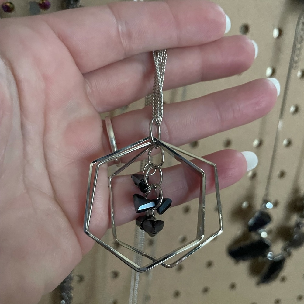 Extra long silver chain geometric necklace with centered blue beads.